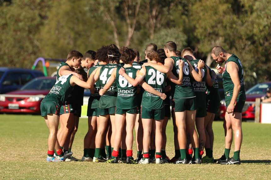 Blackwood Football Club logo players in huddle